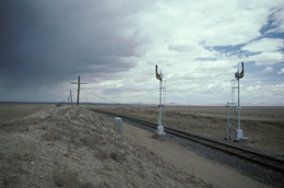 Semaphore signals on the old Sante Fe railroad with an approaching storm south of Raton, NM.